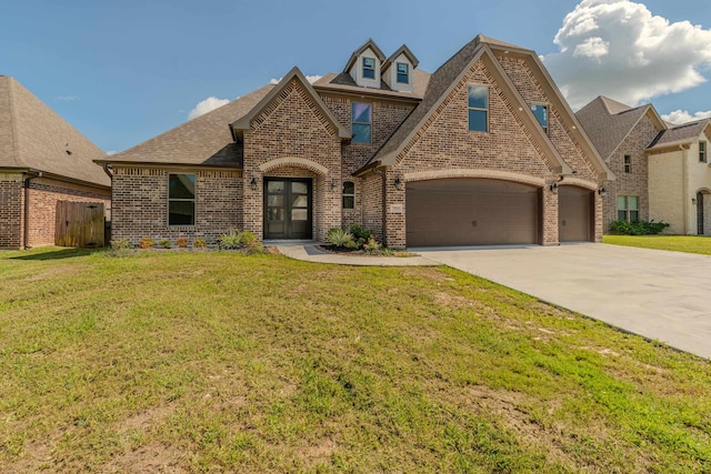 view of front facade with an attached garage, a front lawn, and brick siding