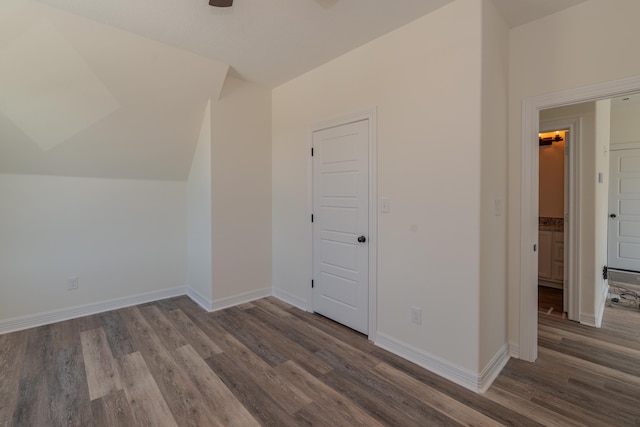 interior space featuring vaulted ceiling, ceiling fan, baseboards, and wood finished floors