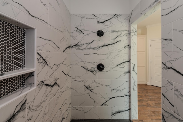 full bath featuring a marble finish shower and wood finished floors