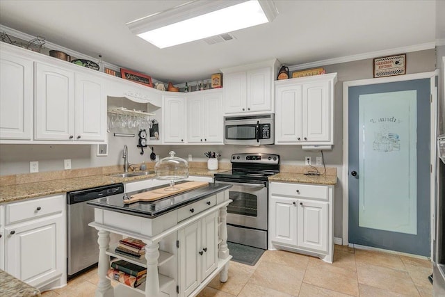 410 Christy Ln, Bridge City, TX 77611 - kitchen with appliances with stainless steel finishes, white cabinetry, open shelves, a kitchen island, and ornamental molding