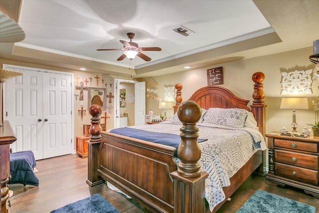 410 Christy Ln, Bridge City, TX 77611 - bedroom with a raised ceiling, ornamental molding, wood finished floors, a closet, and ceiling fan