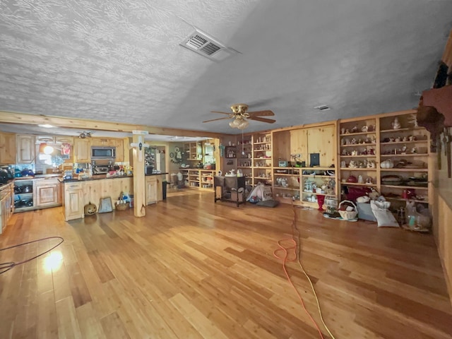 1537 Hillebrandt Acres, Beaumont, TX 77705 - miscellaneous room with light wood-type flooring, a textured ceiling, and ceiling fan