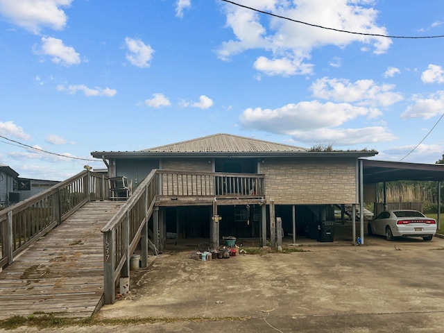 1537 Hillebrandt Acres, Beaumont, TX 77705 - view of front of house with driveway, metal roof, a wooden deck, and stairway
