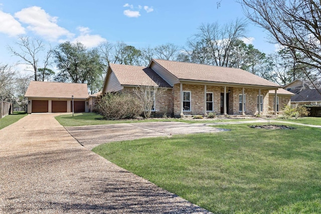 view of front of home featuring a garage, brick siding, an outdoor structure, and a front yard