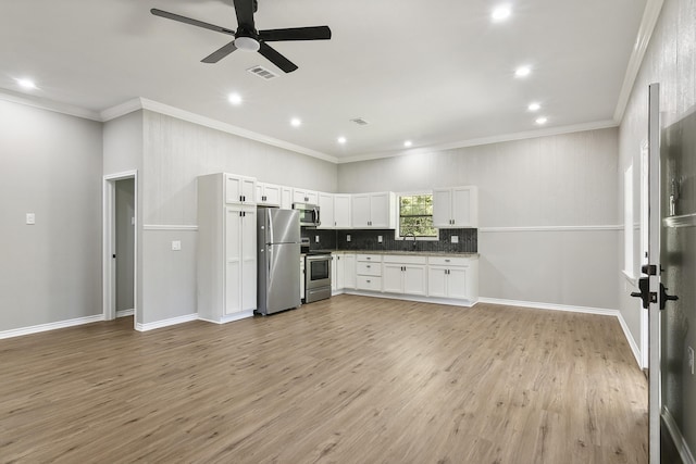 kitchen featuring stainless steel appliances, backsplash, light wood-style floors, open floor plan, and white cabinetry