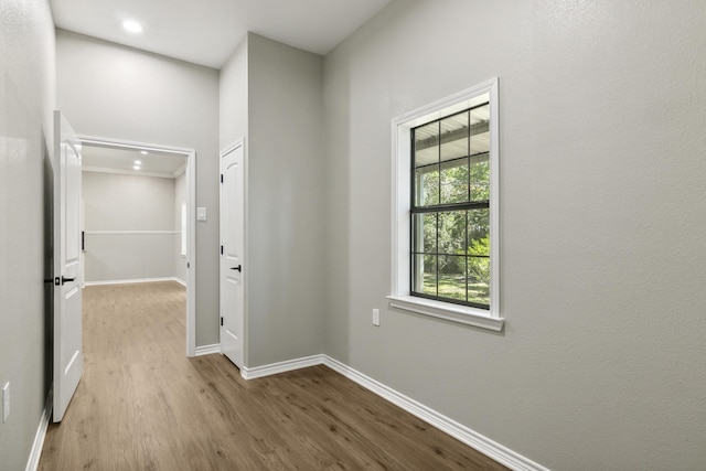 hallway with wood finished floors and baseboards