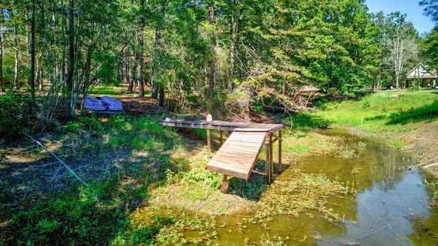 view of dock with a forest view