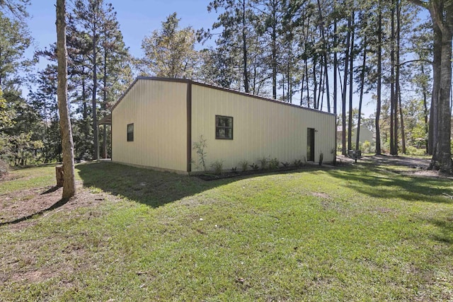 view of side of property featuring a pole building, a yard, and an outdoor structure