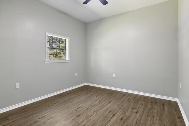 spare room with ceiling fan, wood finished floors, and baseboards