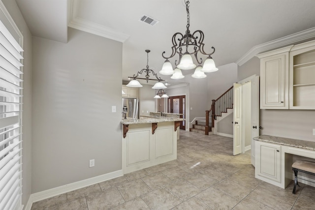 kitchen with crown molding, cream cabinets, a kitchen breakfast bar, and stainless steel fridge with ice dispenser