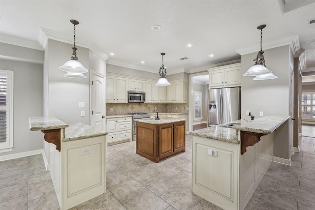 kitchen with a breakfast bar, backsplash, appliances with stainless steel finishes, a sink, and an island with sink