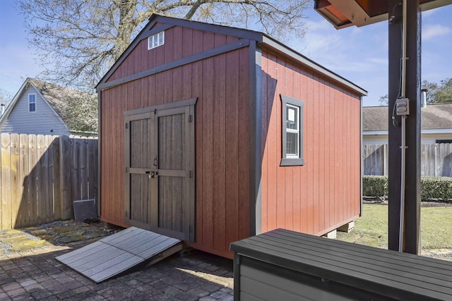 view of shed featuring fence