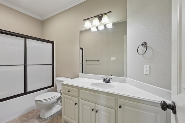 bathroom with ornamental molding, vanity, toilet, and bath / shower combo with glass door