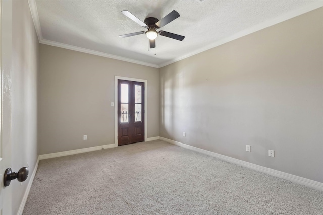 unfurnished room with baseboards, a ceiling fan, light colored carpet, crown molding, and a textured ceiling