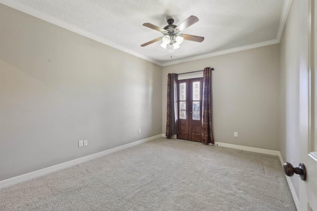 unfurnished room featuring crown molding, baseboards, a textured ceiling, and light colored carpet