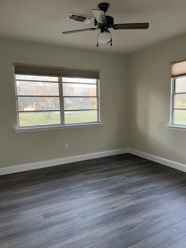 unfurnished room featuring dark hardwood / wood-style floors and ceiling fan