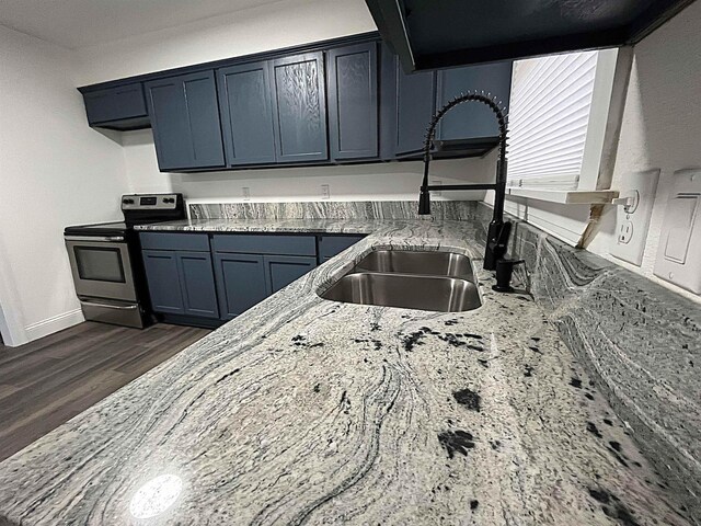 kitchen with sink, electric range, dark wood-type flooring, and light stone countertops