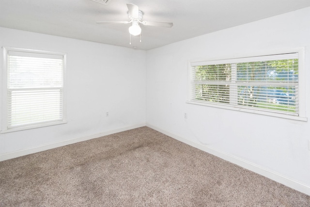 carpeted empty room with plenty of natural light and ceiling fan