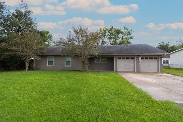 ranch-style house with a garage and a front lawn