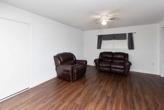 living area with dark wood-type flooring and ceiling fan