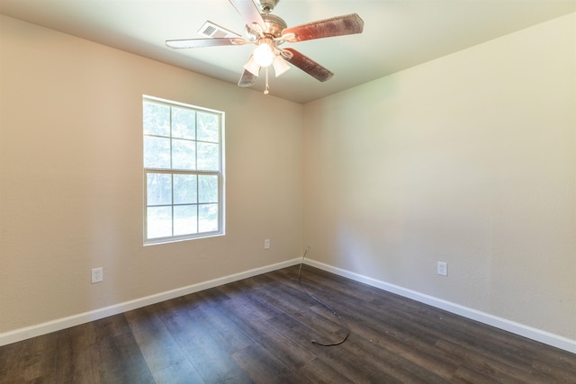 empty room with ceiling fan and dark hardwood / wood-style floors