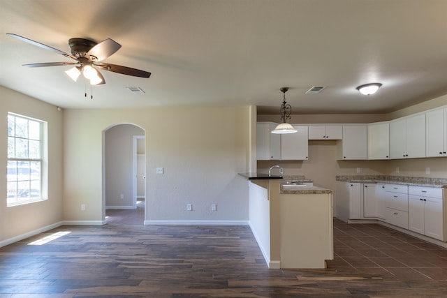 kitchen featuring dark hardwood / wood-style flooring, ceiling fan, sink, decorative light fixtures, and white cabinetry