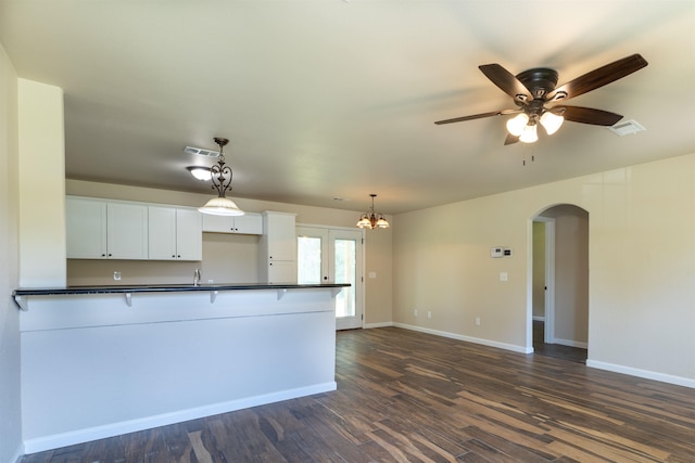 kitchen featuring white cabinetry, sink, dark wood-type flooring, decorative light fixtures, and ceiling fan with notable chandelier