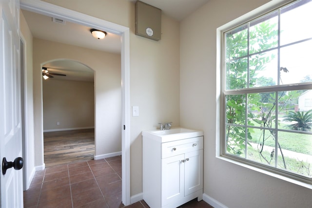 bathroom featuring tile patterned flooring, vanity, and ceiling fan