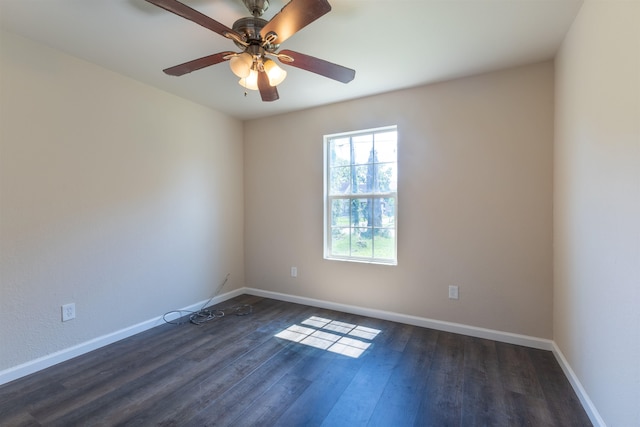 empty room with dark hardwood / wood-style floors and ceiling fan