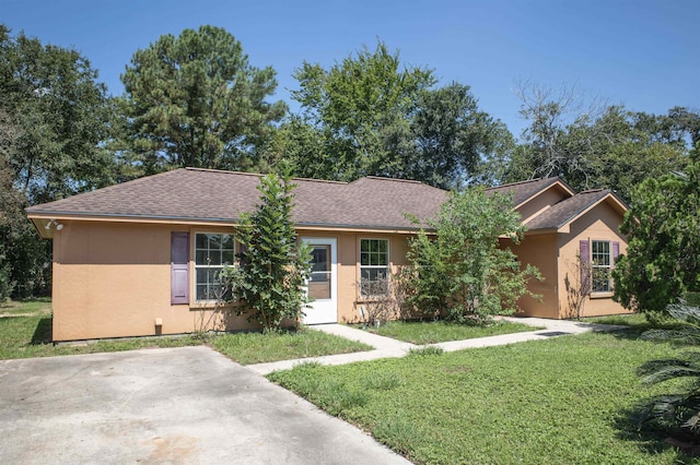 ranch-style home with a front lawn