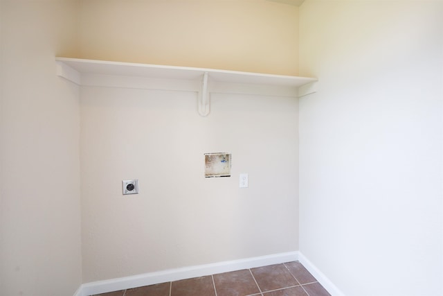 laundry area with electric dryer hookup, dark tile patterned floors, and washer hookup