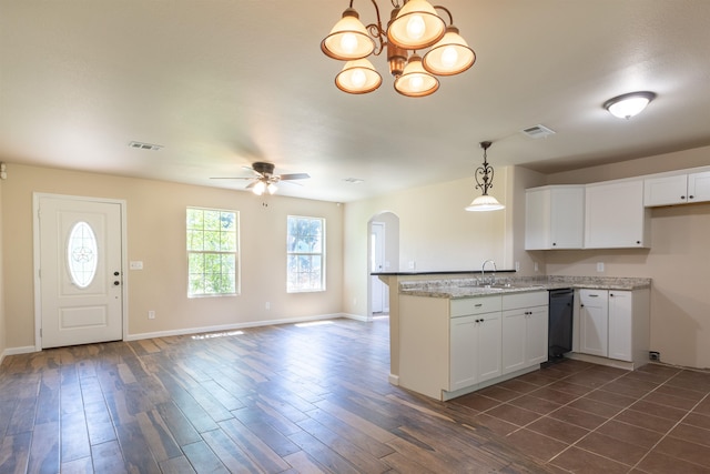 kitchen featuring kitchen peninsula, ceiling fan with notable chandelier, sink, pendant lighting, and white cabinets