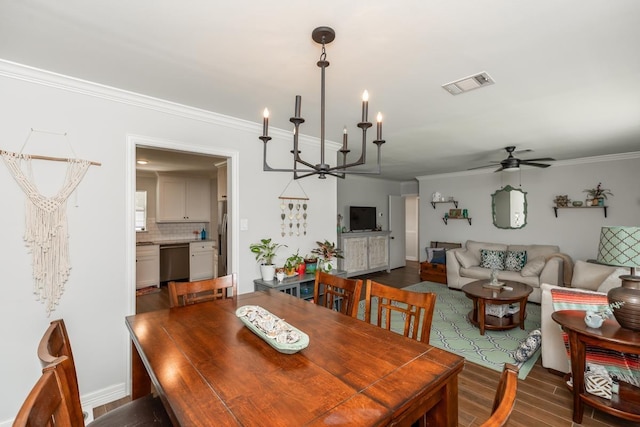 3750 Empire Row, Beaumont, TX 77706 - dining area with crown molding, ceiling fan, dark wood finished floors, and a chandelier