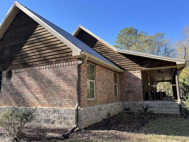 view of side of home featuring ceiling fan and a porch