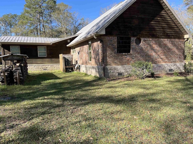 view of side of home featuring a lawn