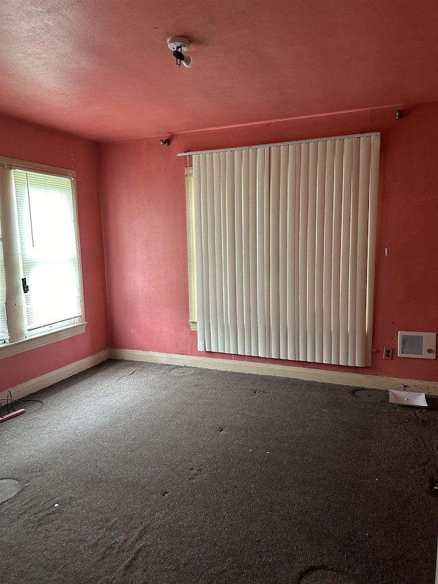 empty room featuring carpet floors and radiator