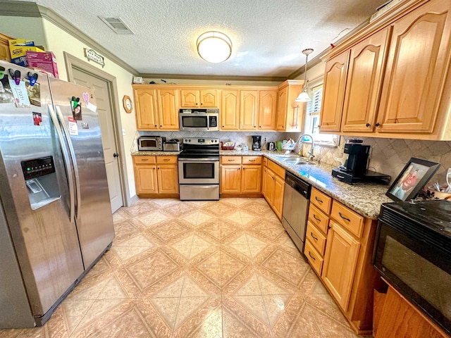 kitchen with light stone countertops, stainless steel appliances, crown molding, sink, and hanging light fixtures