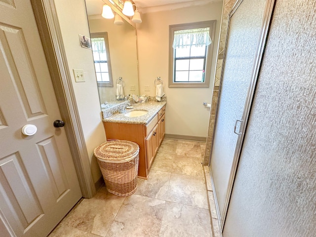 bathroom featuring vanity, an inviting chandelier, and walk in shower