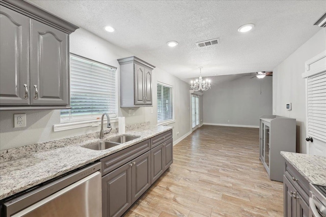 1663 Bluebonnet St, Vidor, TX 77662 - kitchen featuring a sink, dishwasher, gray cabinetry, a ceiling fan, and light wood-style floors