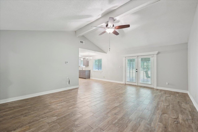 1663 Bluebonnet St, Vidor, TX 77662 - unfurnished living room with a ceiling fan, a chandelier, wood finished floors, baseboards, and a textured ceiling