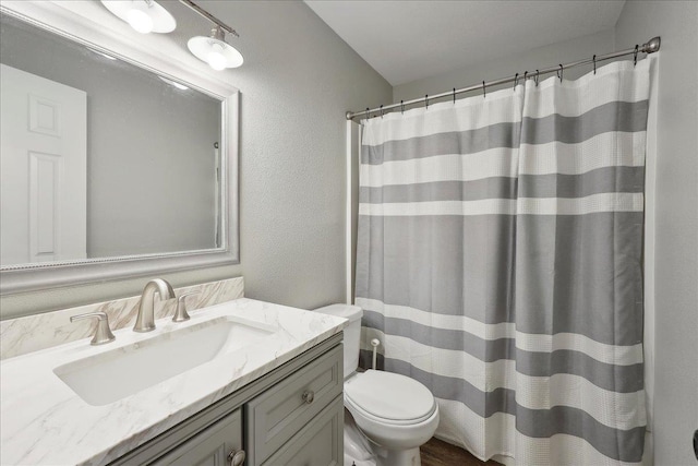 1663 Bluebonnet St, Vidor, TX 77662 - bathroom with toilet, vanity, a shower with shower curtain, and a textured wall