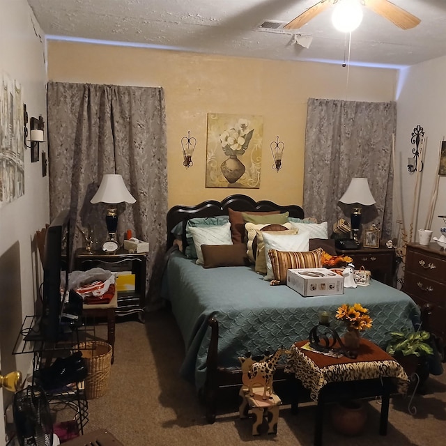 bedroom with carpet floors, ceiling fan, and visible vents