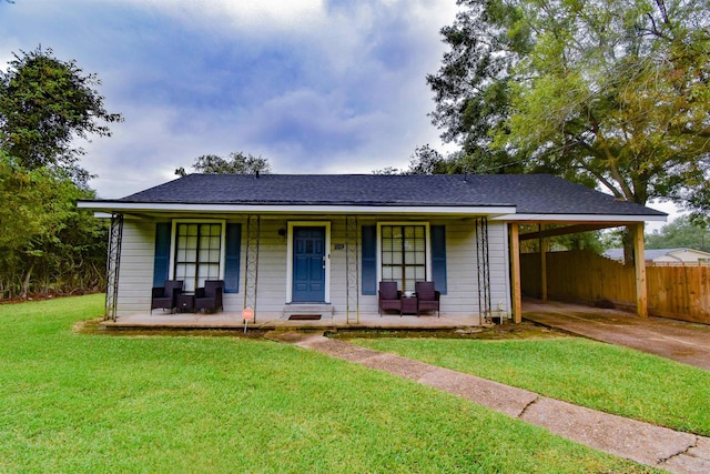 view of front facade with a carport, covered porch, and a front yard