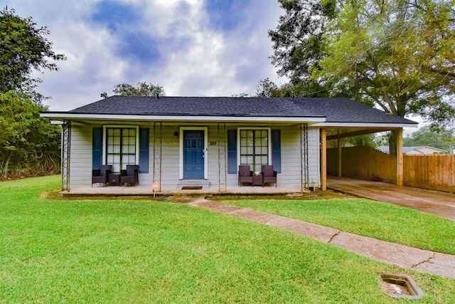 single story home featuring a carport, covered porch, and a front lawn