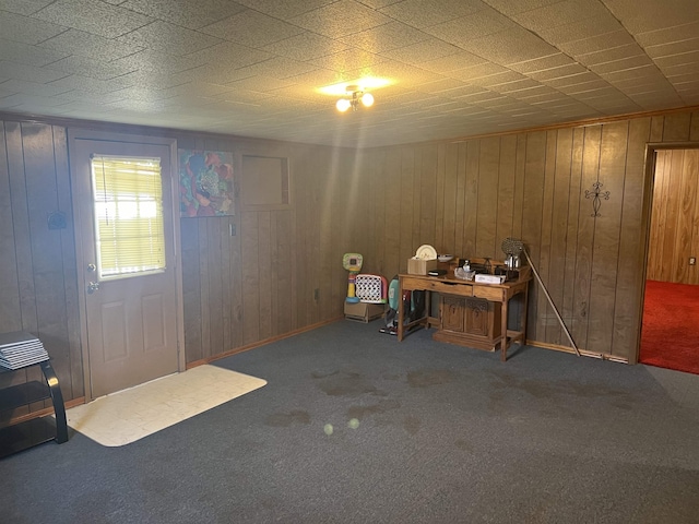 office with wood walls and carpet floors