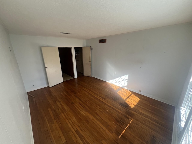 empty room featuring dark wood-type flooring