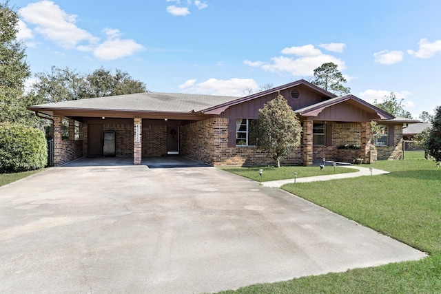 single story home featuring an attached carport, driveway, brick siding, and a front yard