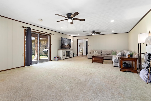 carpeted living room with recessed lighting, a ceiling fan, and ornamental molding