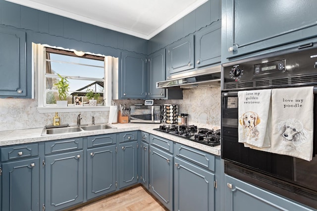 kitchen featuring a sink, black appliances, under cabinet range hood, crown molding, and backsplash