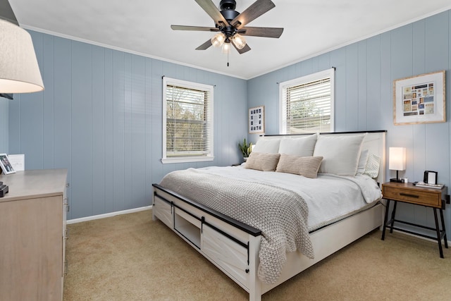 bedroom featuring a ceiling fan, light colored carpet, baseboards, and ornamental molding